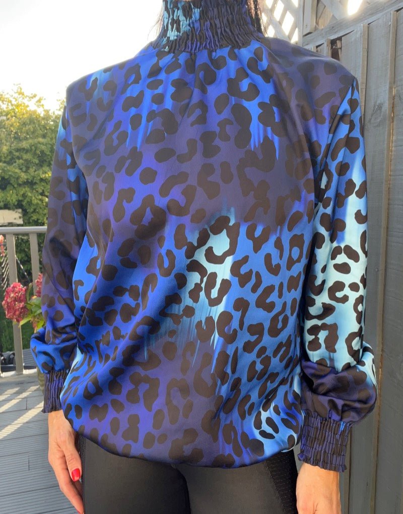 Looser fitting animal print high neck blouse