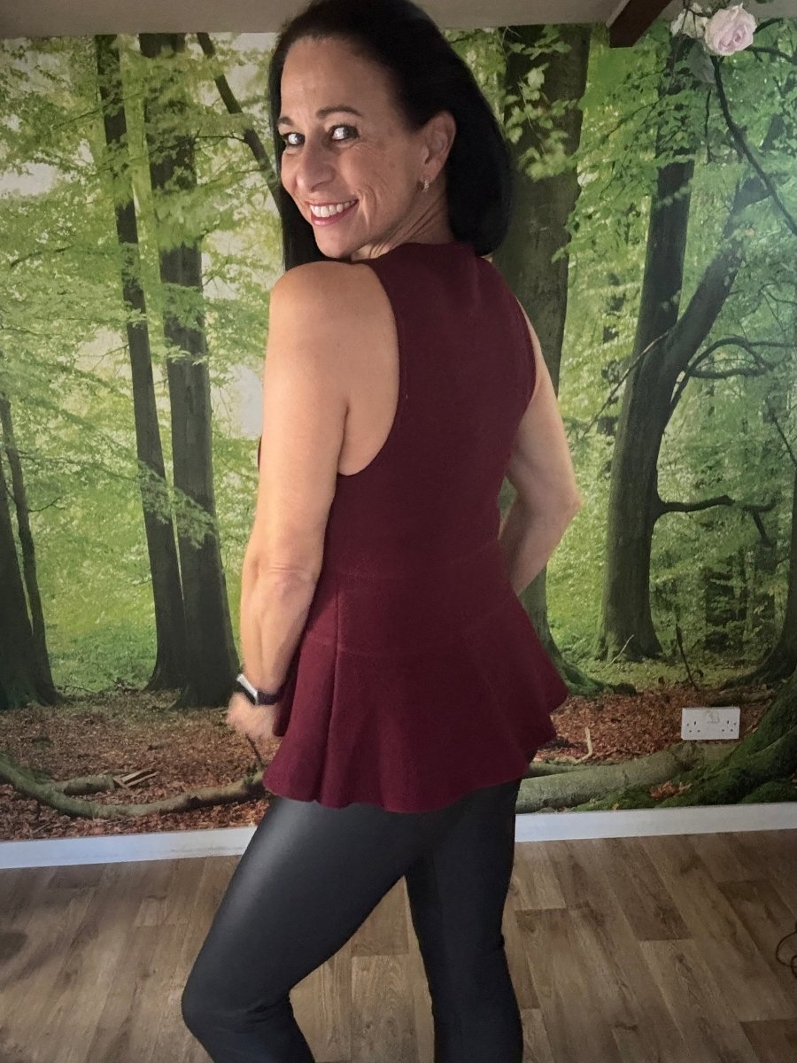 Peplum sleeveless knit top