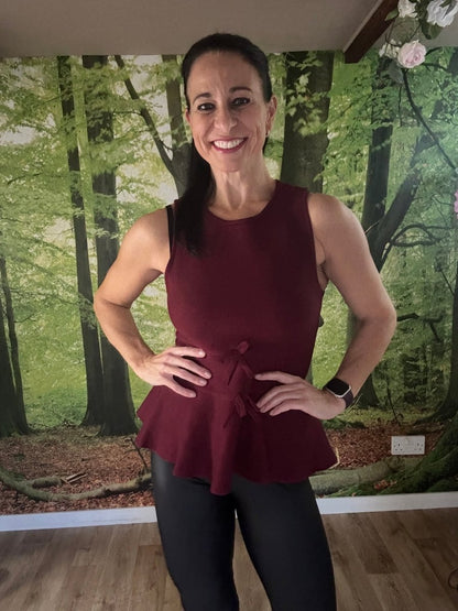 Peplum sleeveless knit top